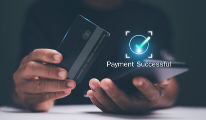 Digital payment concept. Businessman holding a credit card and smartphone with a "Payment Successful" sign. Representing secure online transactions and modern financial technology. Online banking.