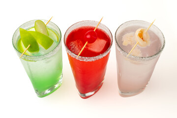 Colorful cocktails with fruit garnish on white background – refreshing summer drinks for party and celebration