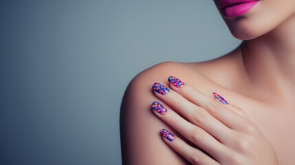 A woman's hand with beautifully manicured nails featuring a bold, colorful polka dot design. The hand is gently touching her shoulder.