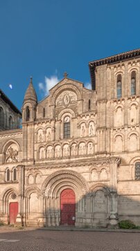 Eglise Abbatiale Sainte-Croix timelapse hyperlapse in Bordeaux, France, Romanesque Catholic church with a medieval facade. Landmark showcases rich architectural and cultural heritage under a blue sky