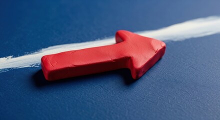 Red Arrow Pointing Forward on Blue Surface with White Line.