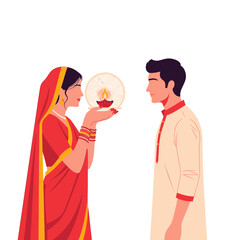 Woman in sari holding a diya lamp towards a man in traditional attire, celebrating a cultural event.