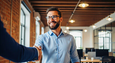 Fototapeta premium Happy professional shaking hands in modern office, sealing a deal, business partnership, successful teamwork