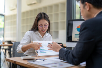 Businesswoman showing marketing results to manager using charts and graphs