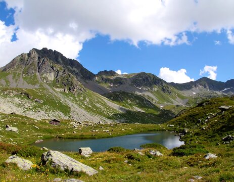 Mountain lake vista under a partly cloudy sky