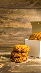 Stacked cookies in a white box on a wooden table