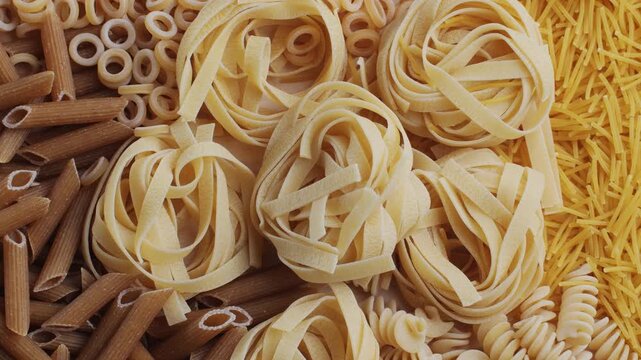 Pasta mix, different Italian tagliatelle fussili pasta packaging window, Fettuccine pasta, close up, not cooked