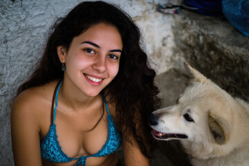 woman sitting on steps of her home joyfully smiling at her dog exuding warmth and gratitude
