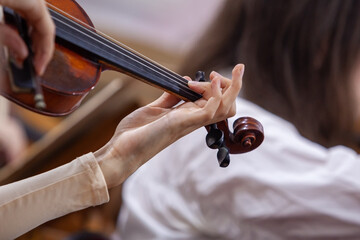 Hand of a girl playing the violin in an orchestra © furtseff