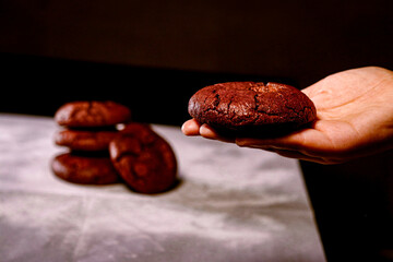 Hand holding red velvet cookie