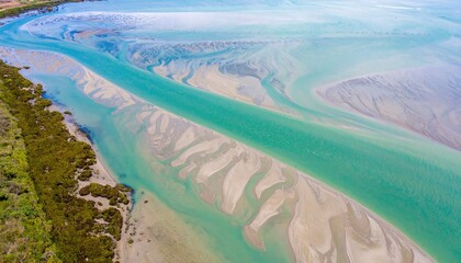 Aerial View of a Serene Estuary with Tidal Feathers and Plumes