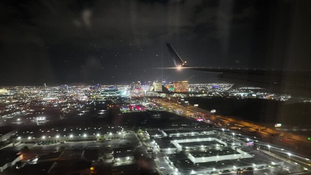 Airplane Approaches Las Vegas Strip at Night With Bright Lights
