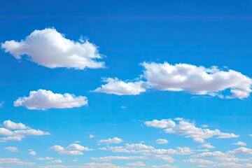 Vast, cerulean sky dotted with fluffy white clouds