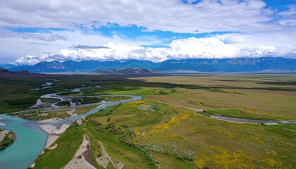 Aerial View of Braided Teal River Delta and Serene Field