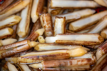Close-up of Fresh Razor Clams in a Cooking Pan with Oil and Seasonings