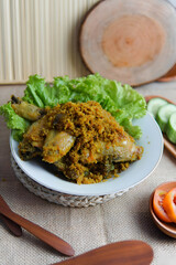 Traditional Spicy Chicken Dish with Vegetables on White Plate in Rustic Setting