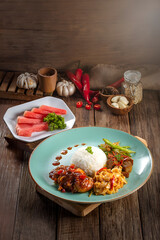 Traditional Asian Style Curry Meal with Rice and Fresh Fruits on Wooden Table