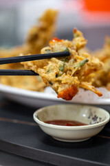 Delicious Tempura with Dipping Sauce Served on a Black Tray