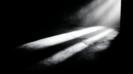 Dramatic spotlight beams cutting through darkness, illuminating dust particles and casting strong shadows on a rough, textured surface