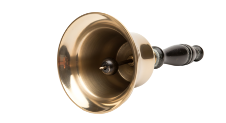 A shiny brass handbell with a dark wooden handle resting on a light surface in a studio setting