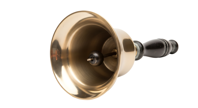 A shiny brass handbell with a dark wooden handle resting on a light surface in a studio setting