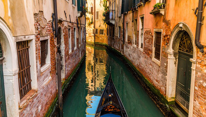 Gondola on a Narrow Venetian Canal at Sunset in Venice, Italy