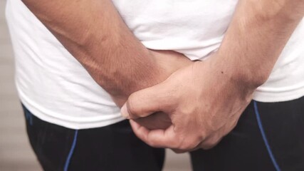 man holding his groin 4k video