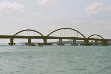 View from a bridge over the sea with tree arcs which connecting island and downtown area