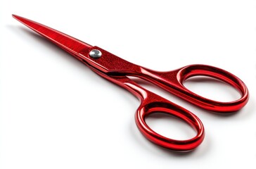 Red scissors lie diagonally on a white surface, angled. Light reflections show the metallic sheen of the tool