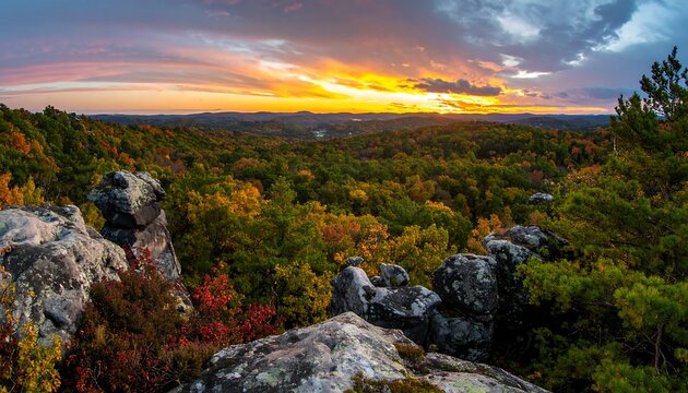 Panoramic vista of a vibrant autumn landscape at sunset, showcasing a valley of colorful trees and rock formations from a high vantage point.
