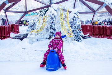 A little girl on the ice rink