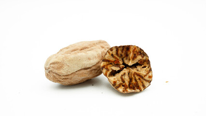 Dried nutmeg or seed of Myristica fragrans, or biji pala. Isolated on white background