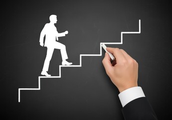 Businessman silhouette climbing chalk stairs to success