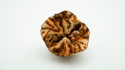 Dried nutmeg or seed of Myristica fragrans, or biji pala. Isolated on white background