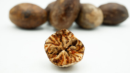 Dried nutmeg or seed of Myristica fragrans, or biji pala. Isolated on white background