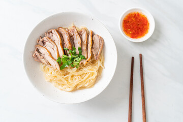 dried noodles with stewed duck in white bowl