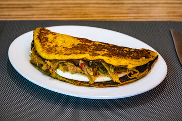 Cachapa, a yellow corn tortilla filled with shredded beef and white cheese