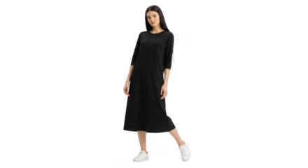 A young woman with long dark hair, wearing a black midi dress and white sneakers, poses confidently on a plain transparent background