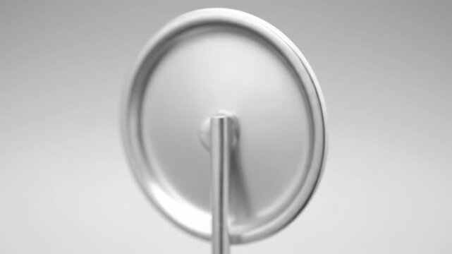 Blank Round Pin Button Mockup - Close-up shot of a blank, round pin button with a shiny silver back, perfect for showcasing custom designs or branding.