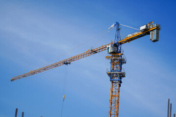 A towering crane reaches for the sky. A symbol of construction, urban development, and engineering.