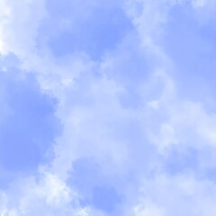 Light blue sky with scattered, soft white clouds