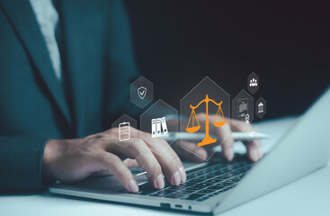 Businessman typing on laptop with digital law and justice scale icon, symbolizing legal services, compliance, corporate governance, law firm technology, business regulation for professional solutions.
