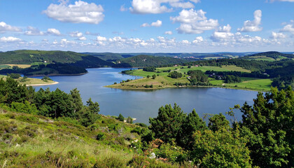 Fototapeta premium Vast Natural Lake Landscape with Green Hills and Blue Sky
