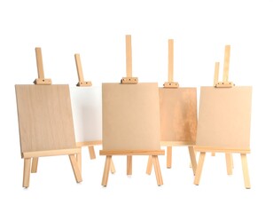 Group of small wooden easels with blank canvases