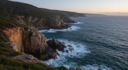 Fototapeta premium Rugged coastline with cliffs, ocean waves, and coastal vegetation at sunset