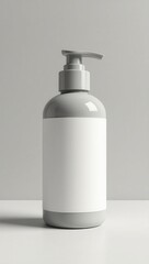 A gray pump bottle with a blank white label, against a neutral background, presents a clean and modern aesthetic.