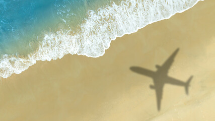 Aerial view of shadow passenger plane silhouette and sandy beach blue sea with waves at sea beach summer vacation sea travel concept	