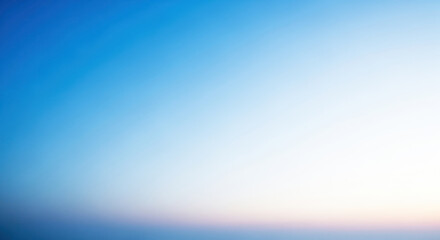 A serene, blue sky with a hint of pink at the horizon.