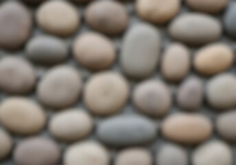 Abstract blurred neutral smooth river pebbles