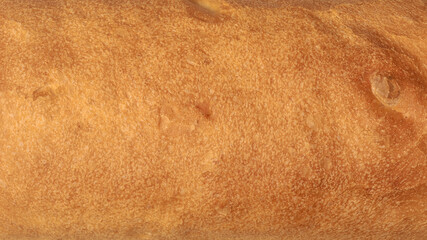 textured crust of loaf of bread fills the entire frame, natural and wholesome food background for recipe blogs and food photography, taken from above